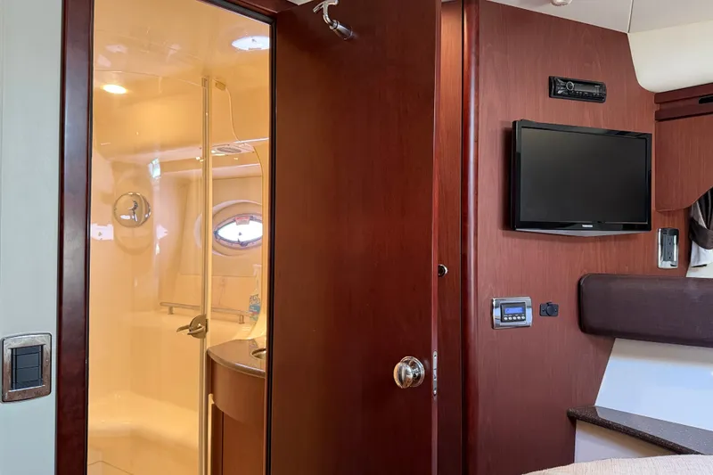 Slide: The Image of Interior of a 2014 Meridian 441 Sedan with wood doors, TV, and bathroom. - 26