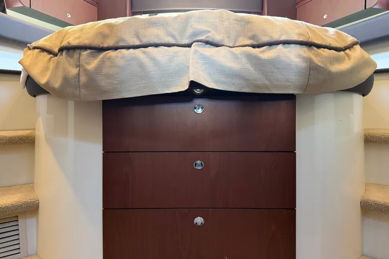 Slide: The Image of The cabin of a 2014 Meridian 441 Sedan with a cushioned bench and drawers underneath. - 23