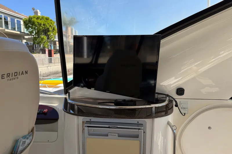 Slide: The Image of Interior of a 2014 Meridian 441 Sedan featuring a TV on a table. - 44