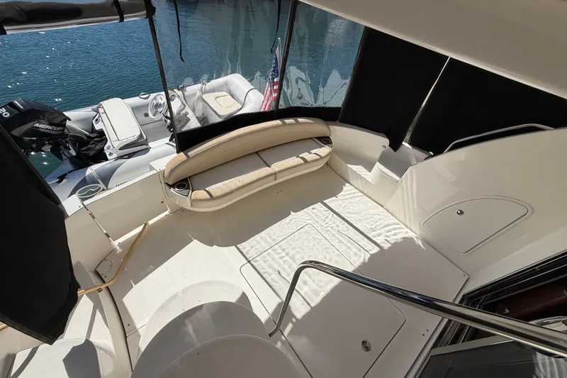 Slide: The Image of The image shows the spacious aft deck of a 2014 Meridian 441 Sedan with a beige seating area. - 37