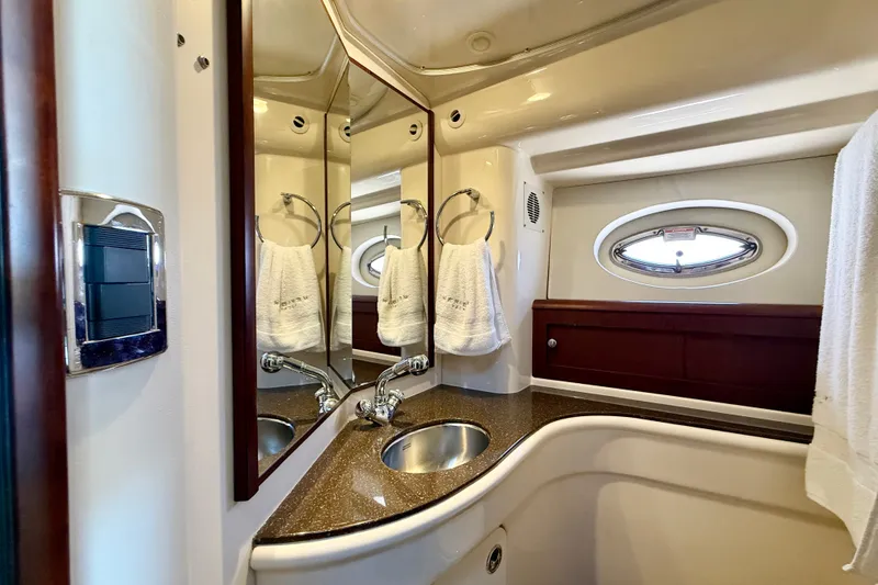 Slide: The Image of The image shows an elegant yacht bathroom with a sink, mirrors, and a porthole. - 36