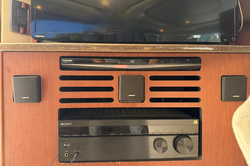 Slide: The Image of An entertainment system with a Sony amplifier, Bose speakers, and a Toshiba Blu-ray player. - 16