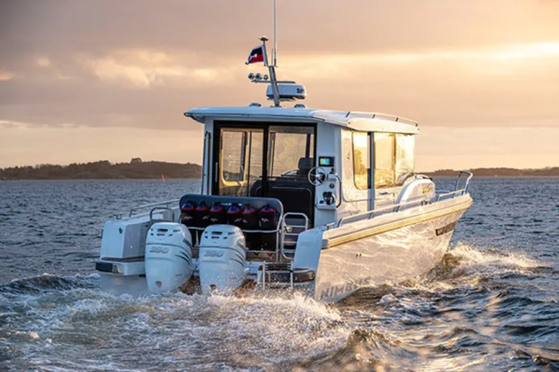 Slide: The Image of 2025 Nimbus Commuter 11 boat cruising on open water at sunset. - 5