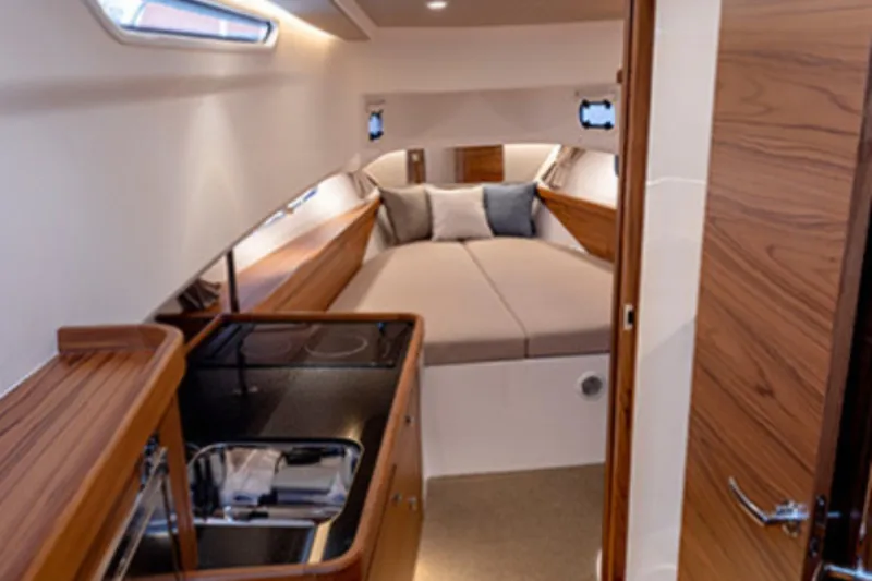 Slide: The Image of Luxurious interior of 2025 Nimbus Commuter 11 boat with cozy bed and kitchenette. - 4