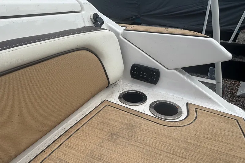 Slide: The Image of 2021 Yamaha Boats 275SE interior with cup holders and cushioned seating. - 11