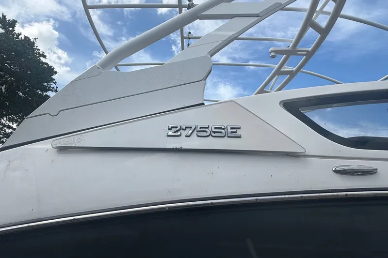 Slide: The Image of 2021 Yamaha Boats 275SE model, showcasing sleek design against a blue sky backdrop. - 13