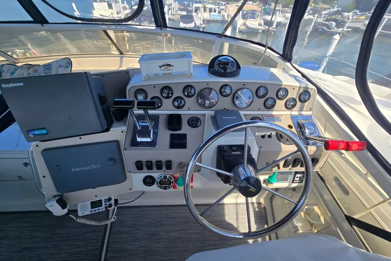 Slide: The Image of Cockpit of a 1998 Carver 370 Voyager with steering wheel and navigation instruments. - 12