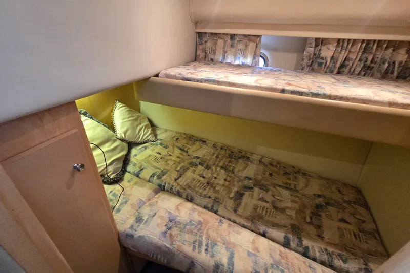 Slide: The Image of Interior cabin of 1998 Carver 370 Voyager with bunk beds and patterned bedding. - 5