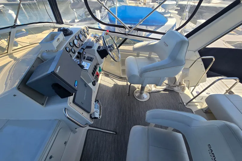 Slide: The Image of Cockpit of 1998 Carver 370 Voyager yacht with steering wheel and control panel. - 11