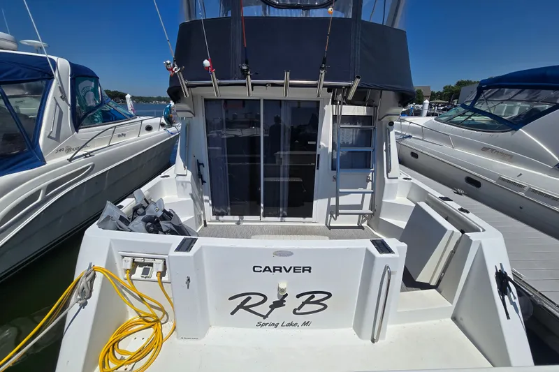 Slide: The Image of 1998 Carver 370 Voyager docked, rear view with ladder and equipment, Spring Lake, MI. - 4