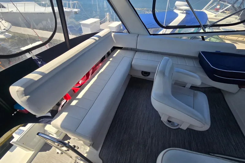 Slide: The Image of Interior of 1998 Carver 370 Voyager yacht with white seating and helm chair. - 10