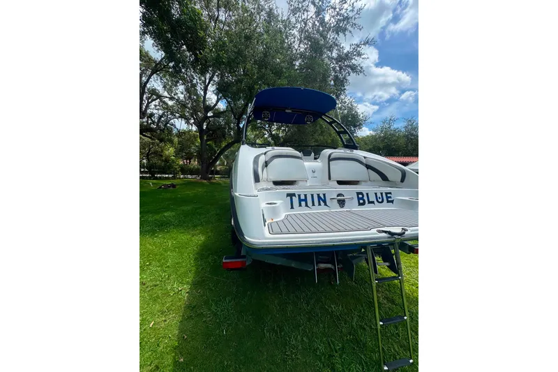 Slide: The Image of 2015 Yamaha Boats AR240 on grass, rear view with "Thin Blue" text. - 14