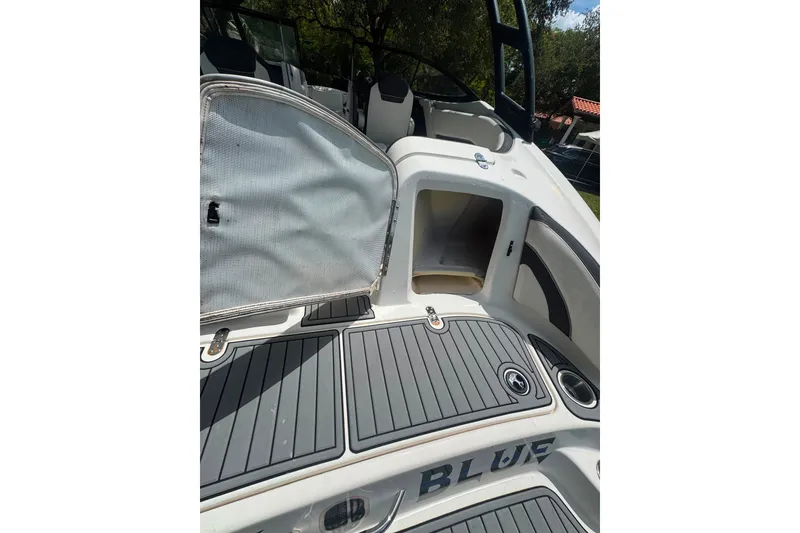 Slide: The Image of 2015 Yamaha AR240 boat interior with open storage compartment and sleek deck design. - 24