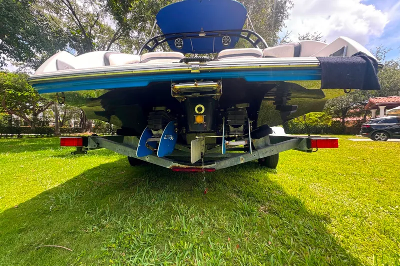 Slide: The Image of Rear view of a 2015 Yamaha Boats AR240 on a trailer, parked on grass. - 48