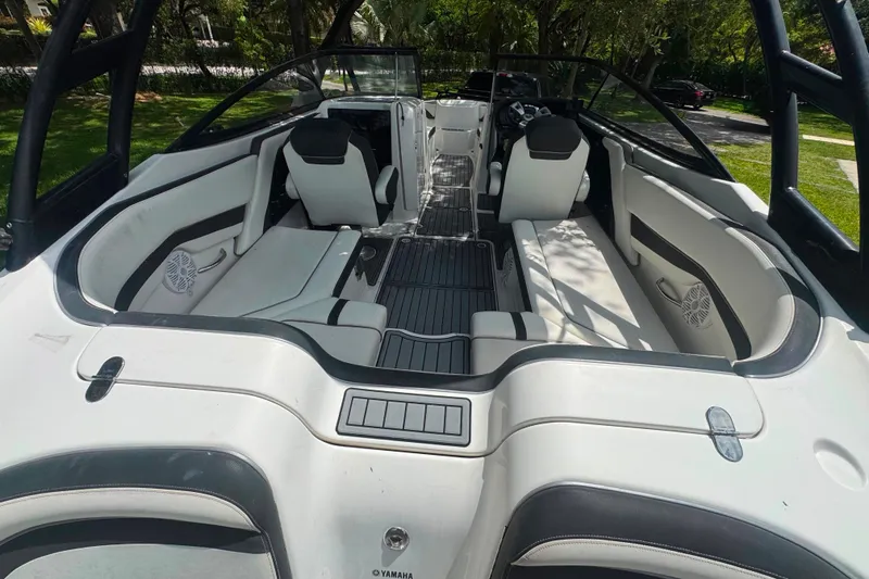 Slide: The Image of 2015 Yamaha Boats AR240 interior with white seating and sleek design. - 23