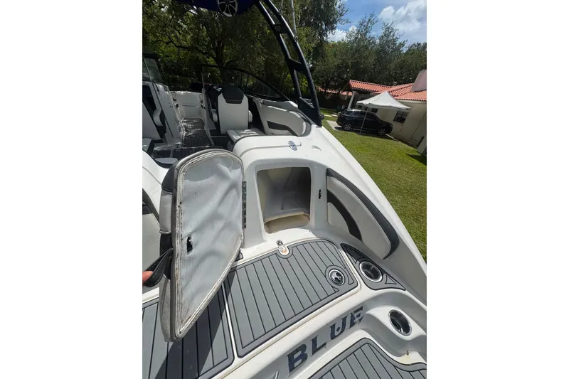 Slide: The Image of 2015 Yamaha Boats AR240 interior with open storage compartment, sleek design, and comfortable seating. - 35