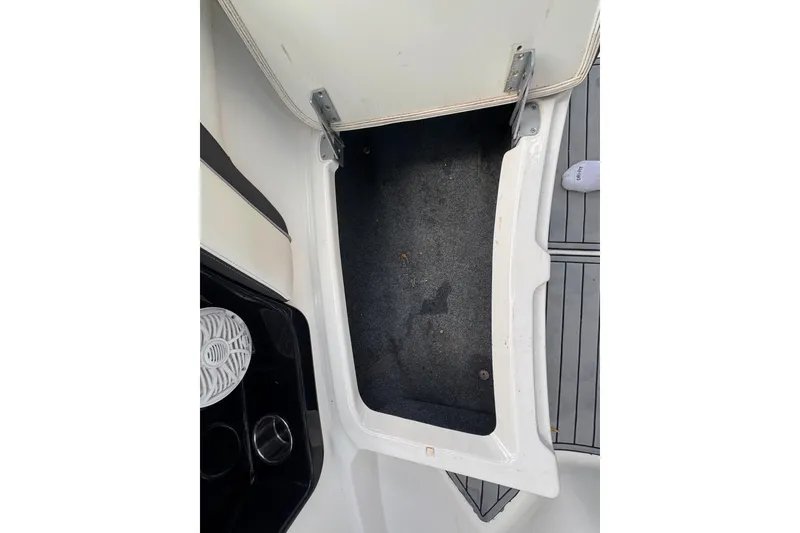 Slide: The Image of Open storage compartment on a 2015 Yamaha Boats AR240, featuring a clean interior. - 42