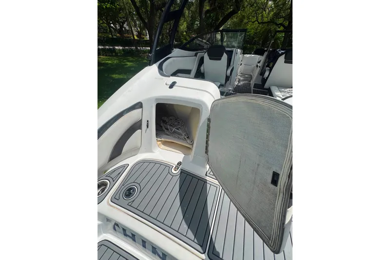 Slide: The Image of 2015 Yamaha Boats AR240 interior with open storage compartment and seating area. - 22