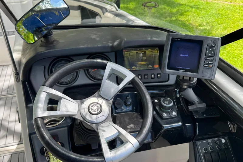 Slide: The Image of Dashboard of a 2015 Yamaha Boats AR240 with Garmin navigation system and steering wheel. - 29