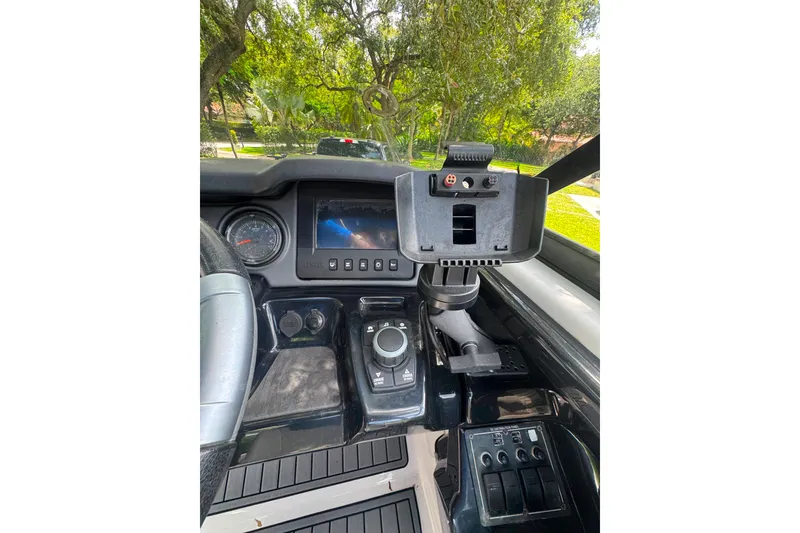 Slide: The Image of Dashboard of a 2015 Yamaha Boats AR240, featuring controls and navigation display. - 28