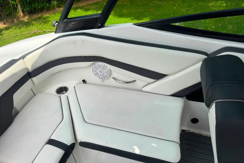 Slide: The Image of Interior seating of a 2015 Yamaha Boats AR240, featuring white and black upholstery. - 25