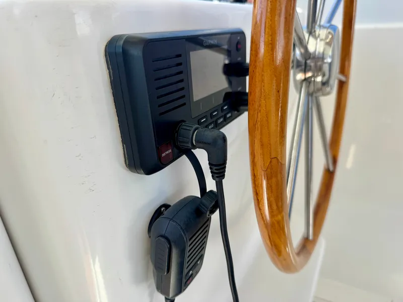 Slide: The Image of Close-up of a wooden steering wheel and radio equipment on a boat. - 20
