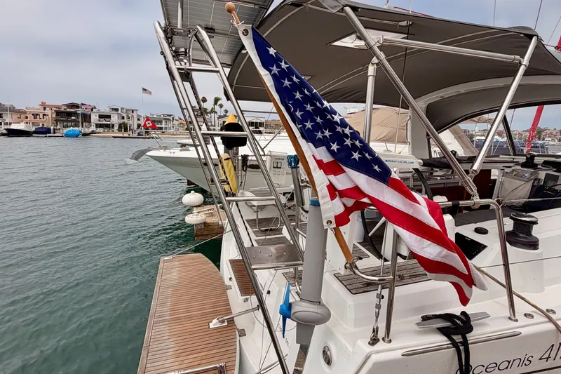 Slide: The Image of 2017 Beneteau Oceanis 41.1 sailboat with American flag docked in a marina. - 13