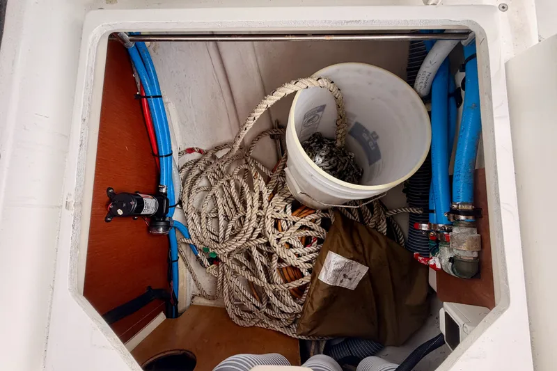 Slide: The Image of Storage compartment of a 2017 Beneteau Oceanis 41.1 with ropes, bucket, and hoses. - 48