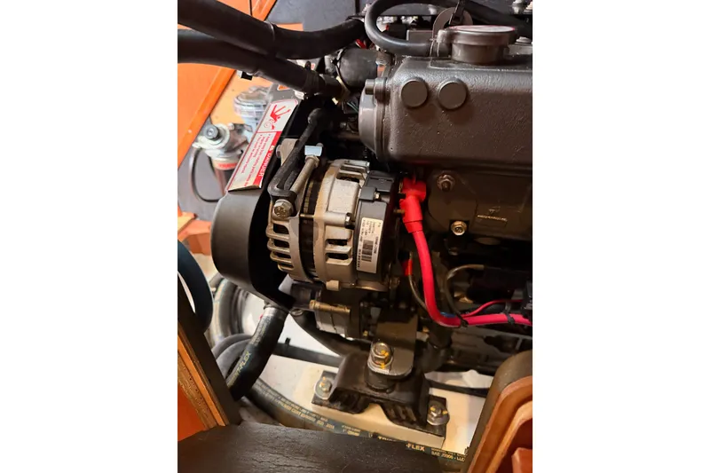 Slide: The Image of Engine compartment of a 2017 Beneteau Oceanis 41.1 sailboat, showing alternator and wiring. - 111