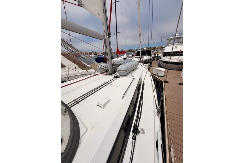 Slide: The Image of 2017 Beneteau Oceanis 41.1 sailboat docked at marina, showcasing sleek deck design. - 15