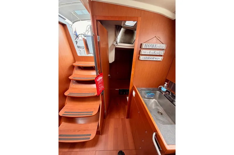 Slide: The Image of Interior of 2017 Beneteau Oceanis 41.1 yacht with wooden stairs and compact kitchen. - 67
