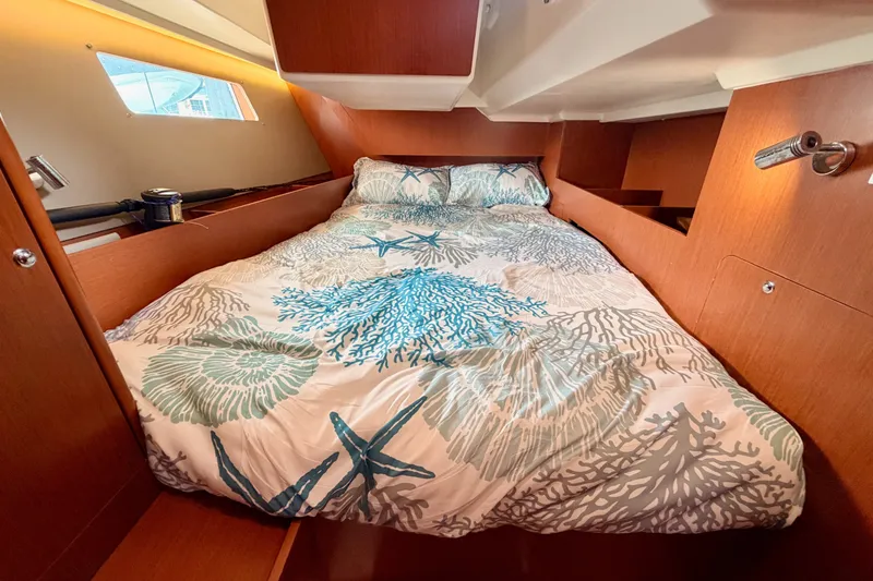 Slide: The Image of Cozy cabin interior of 2017 Beneteau Oceanis 41.1 with nautical-themed bedding. - 79