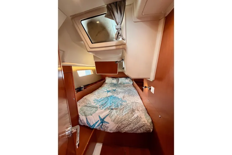 Slide: The Image of Cozy cabin interior of 2017 Beneteau Oceanis 41.1 sailboat with skylight and patterned bedding. - 78
