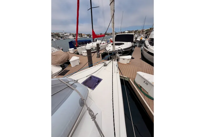 Slide: The Image of 2017 Beneteau Oceanis 41.1 sailboat docked at a marina, surrounded by other boats. - 17