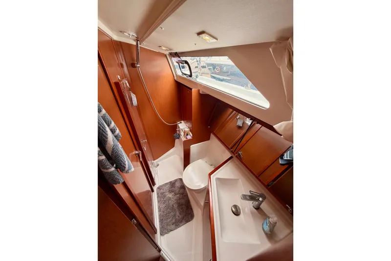 Slide: The Image of Interior of 2017 Beneteau Oceanis 41.1 yacht bathroom with wooden cabinetry and modern fixtures. - 81