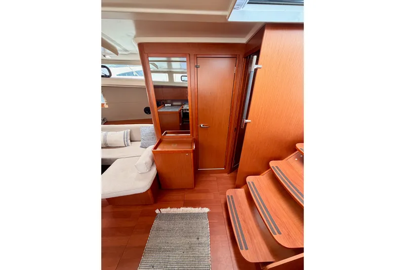 Slide: The Image of Interior of 2017 Beneteau Oceanis 41.1 yacht with wooden finishes and cozy seating area. - 74