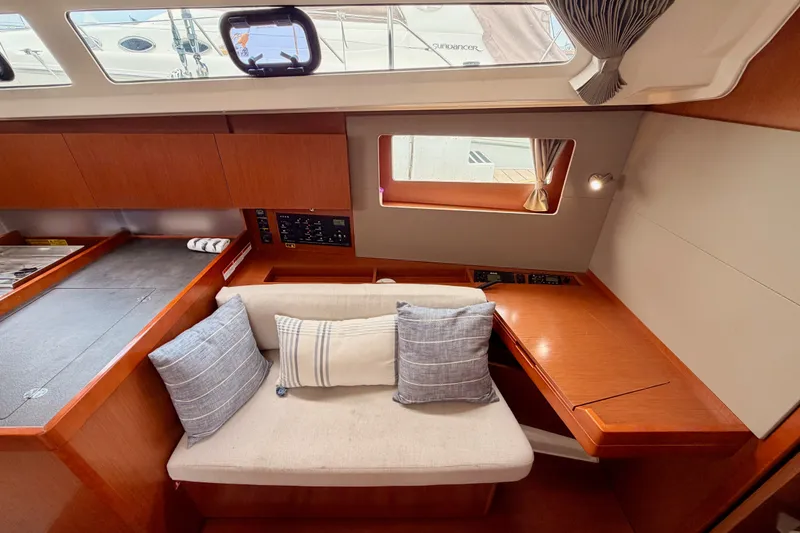 Slide: The Image of Interior of 2017 Beneteau Oceanis 41.1 yacht with cozy seating and wooden finishes. - 90