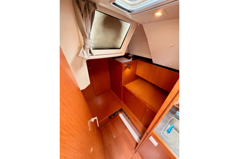 Slide: The Image of Interior of 2017 Beneteau Oceanis 41.1 yacht, featuring wooden cabinetry and a skylight. - 68