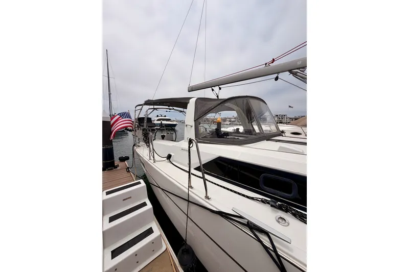 Slide: The Image of 2017 Beneteau Oceanis 41.1 yacht docked, featuring sleek design and American flag. - 11