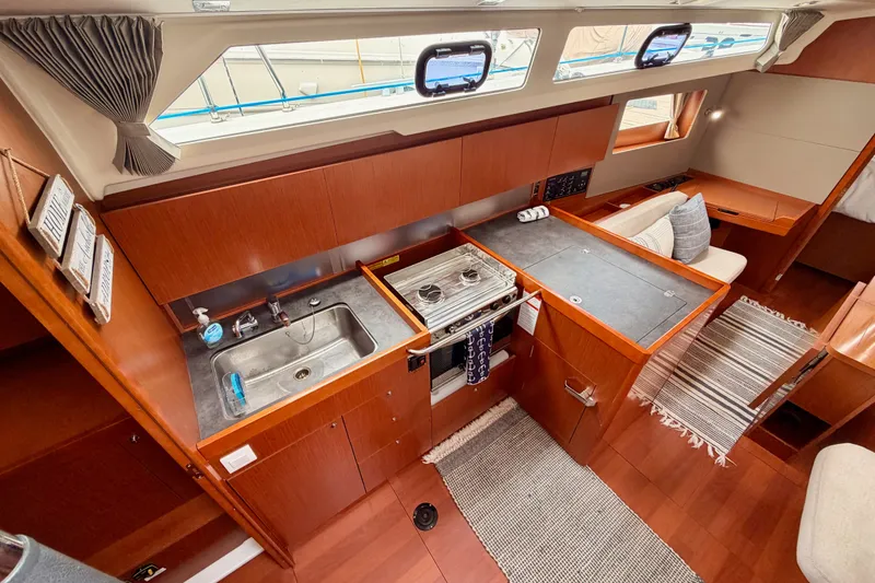 Slide: The Image of 2017 Beneteau Oceanis 41.1 yacht interior with modern kitchen and cozy seating area. - 60