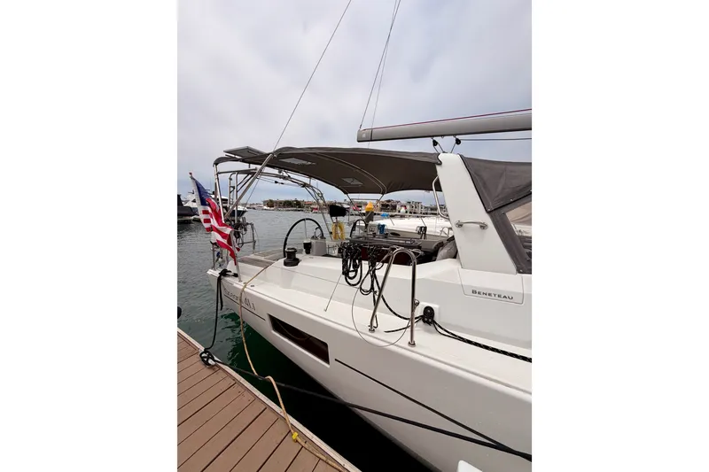 Slide: The Image of 2017 Beneteau Oceanis 41.1 yacht docked at marina, featuring sleek design and American flag. - 12