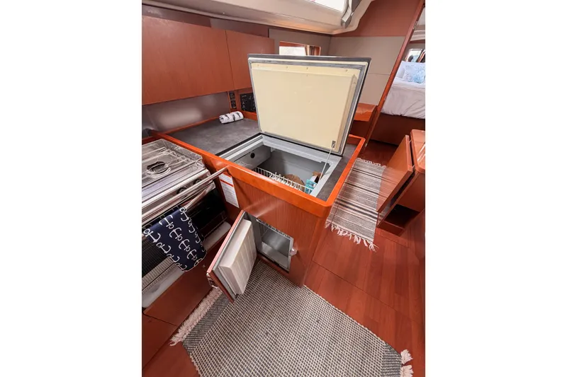 Slide: The Image of Interior of 2017 Beneteau Oceanis 41.1 yacht kitchen with open fridge and stove. - 63