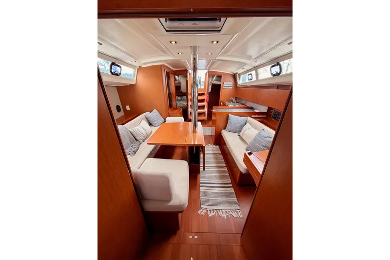 Slide: The Image of Interior of 2017 Beneteau Oceanis 41.1 yacht with cozy seating and wooden finishes. - 103