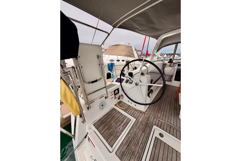 Slide: The Image of Cockpit of 2017 Beneteau Oceanis 41.1 sailboat with steering wheel and teak flooring. - 37