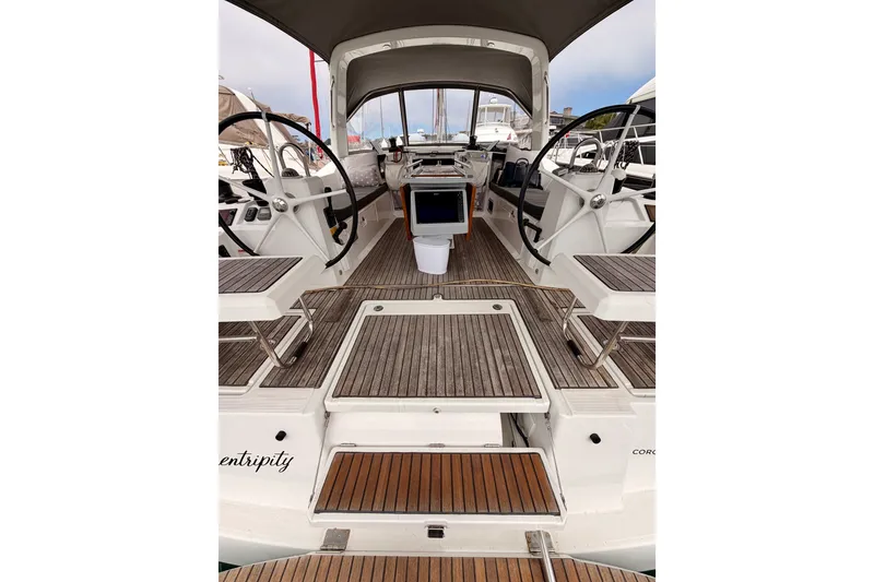 Slide: The Image of 2017 Beneteau Oceanis 41.1 yacht cockpit with dual steering wheels and teak flooring. - 35
