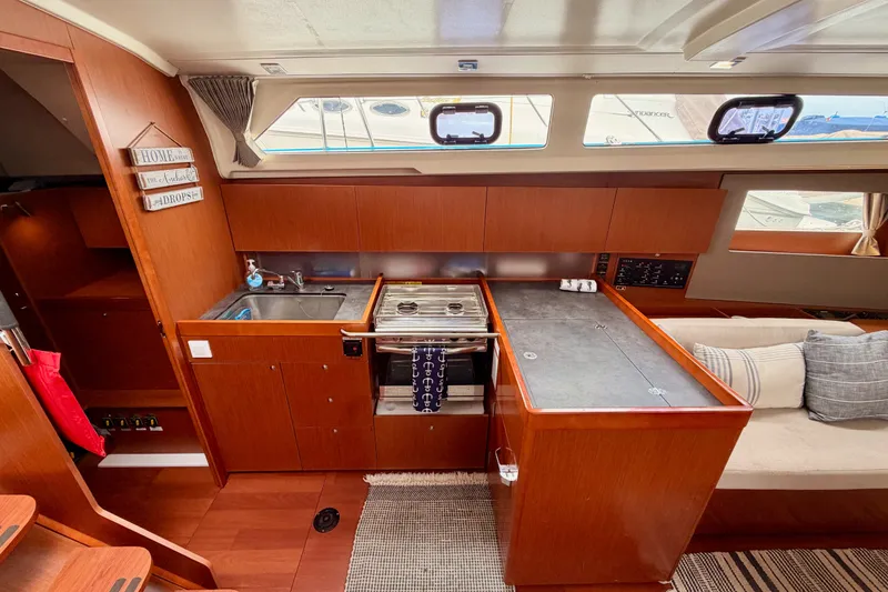 Slide: The Image of Interior of 2017 Beneteau Oceanis 41.1 yacht with modern kitchen and seating area. - 62