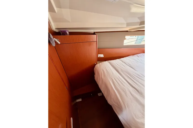 Slide: The Image of Interior cabin of 2017 Beneteau Oceanis 41.1 yacht with wooden paneling and bed. - 98