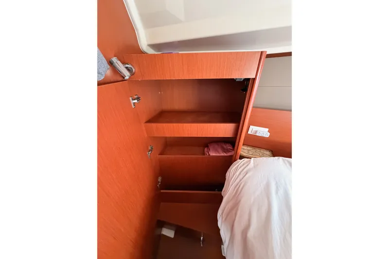 Slide: The Image of Interior cabin storage on 2017 Beneteau Oceanis 41.1 yacht, featuring wooden cabinetry. - 99