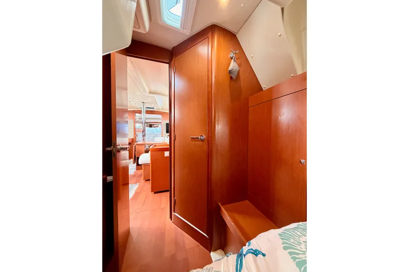 Slide: The Image of Interior of 2017 Beneteau Oceanis 41.1 yacht, featuring wooden cabinetry and cozy cabin space. - 80