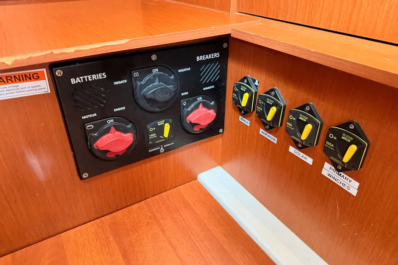 Slide: The Image of Electrical panel on a 2017 Beneteau Oceanis 41.1 yacht, featuring battery and breaker controls. - 73